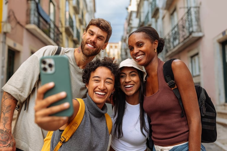 Group of tourists enjoying Berlin walking tour, smiling and taking photos at historic landmark